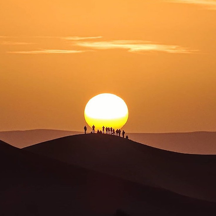 tourists watching sunset view in Merzouga desert