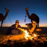 Two men preparing Moroccan tea in the desert of Merzouga